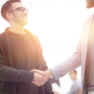 closeup.the handshake between the designer and the client on a Studio background